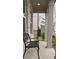 Inviting front porch with a comfortable wrought iron bench, perfect for relaxing outdoors at 2962 Girard Ln, Duluth, GA 30097