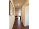 Hallway with hardwood floors, white walls, recessed lighting, and a view to a dining area at 2962 Girard Ln, Duluth, GA 30097