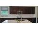Modern kitchen with dark wood cabinets, stainless steel appliances, and white subway tile backsplash at 2962 Girard Ln, Duluth, GA 30097