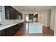Modern kitchen with stainless steel appliances, white countertops, and dark wood cabinetry at 2962 Girard Ln, Duluth, GA 30097