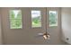 Upstairs landing featuring a modern ceiling fan and large windows offering scenic views of the outdoors at 2962 Girard Ln, Duluth, GA 30097