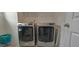 Well-lit laundry area equipped with a modern washer and dryer set for convenient laundry days at 2962 Girard Ln, Duluth, GA 30097