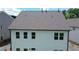 Rear view of home with neutral siding, large backyard, and well-maintained landscaping, ideal for outdoor activities at 2962 Girard Ln, Duluth, GA 30097