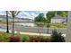 Scenic water view of community pond with lush landscaping, and nearby homes at 2962 Girard Ln, Duluth, GA 30097