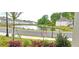 Scenic water view of community pond with lush landscaping and nearby homes at 2962 Girard Ln, Duluth, GA 30097