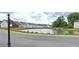 Scenic water view of community pond with lush landscaping, bridge, and nearby homes at 2962 Girard Ln, Duluth, GA 30097