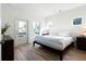 Bright bedroom with white walls, wood floor, and access to a private balcony at 4856 Allatoona Gtwy # 8, Acworth, GA 30101