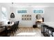 Bright dining area features a built-in bench, modern light fixture, and sleek black chairs at 4856 Allatoona Gtwy # 8, Acworth, GA 30101