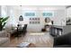 Open-concept living space with kitchen island and dining area featuring a modern table set and natural light at 4856 Allatoona Gtwy # 8, Acworth, GA 30101
