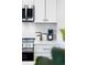 Detailed view of a modern kitchen featuring white cabinetry, quartz countertops, and stainless steel appliances at 4856 Allatoona Gtwy # 8, Acworth, GA 30101