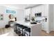 Modern kitchen featuring white cabinets, stainless steel appliances, a quartz island with seating, and stylish decor at 4856 Allatoona Gtwy # 8, Acworth, GA 30101