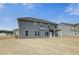 Two-story home featuring a level backyard and covered patio at 512 Dolce Rd, Locust Grove, GA 30248