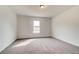 A simple empty bedroom with carpeted floors, neutral paint, and a single window at 512 Dolce Rd, Locust Grove, GA 30248