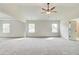 A large bedroom featuring neutral walls, and carpet with a ceiling fan at 512 Dolce Rd, Locust Grove, GA 30248
