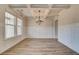 Elegant dining room featuring a coffered ceiling, modern chandelier, and large windows at 512 Dolce Rd, Locust Grove, GA 30248
