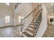 Grand entryway with hardwood floors, a staircase, and views into the living room and kitchen at 512 Dolce Rd, Locust Grove, GA 30248