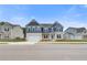 Charming two-story home featuring a blue and white exterior, a well-manicured lawn, and an attached two-car garage at 512 Dolce Rd, Locust Grove, GA 30248