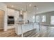 Kitchen island with seating, stainless appliances, and ample natural light at 512 Dolce Rd, Locust Grove, GA 30248