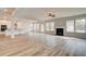 Open concept living room with hardwood floors, fireplace, and seamless flow into the kitchen at 512 Dolce Rd, Locust Grove, GA 30248