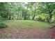 A large, green backyard with plenty of trees, provides privacy and space at 1889 Vesta Ave, Atlanta, GA 30344