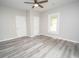 Spacious bedroom with gray flooring, two closets, and a ceiling fan, creating a comfortable retreat at 1889 Vesta Ave, Atlanta, GA 30344