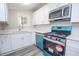 Modern kitchen with white cabinets, stainless steel appliances, and a blue gas range stove at 1889 Vesta Ave, Atlanta, GA 30344