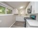 Bright kitchen features new stainless steel appliances, white cabinets, and gray flooring at 1889 Vesta Ave, Atlanta, GA 30344