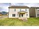 Rear exterior of home with a fire pit, covered patio and a large backyard at 200 Eva Way Ne, Cartersville, GA 30121