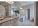 Modern bathroom with double sink vanity, granite countertops, white cabinets, and tiled floors at 200 Eva Way Ne, Cartersville, GA 30121