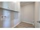 Practical laundry room provides overhead cabinets for storage with hookups for the washer and dryer at 200 Eva Way Ne, Cartersville, GA 30121