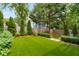 The backyard features artificial turf with well-manicured landscaping and mature trees at 318 5Th Ne St, Atlanta, GA 30308