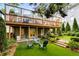 An expansive backyard features artificial turf and a spacious deck with curtains at 318 5Th Ne St, Atlanta, GA 30308