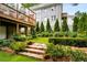 Backyard featuring landscaping with brick stairs and a deck with outdoor furniture at 318 5Th Ne St, Atlanta, GA 30308