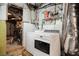 Basement laundry area features a white washer and dryer and wire shelving at 318 5Th Ne St, Atlanta, GA 30308