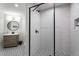 Bathroom featuring modern shower with sleek fixtures, vanity, and patterned tile flooring at 318 5Th Ne St, Atlanta, GA 30308