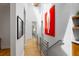 Bright hallway featuring hardwood floors, modern railings, and contemporary artwork, creating a stylish transition between spaces at 318 5Th Ne St, Atlanta, GA 30308