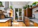Contemporary kitchen with gas range, floating shelves and stainless steel refrigerator at 318 5Th Ne St, Atlanta, GA 30308