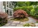 Exterior image showcases lush landscaping, a red Japanese maple, and decorative stone, creating a serene outdoor space at 318 5Th Ne St, Atlanta, GA 30308