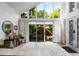 Bright living room with soaring windows, a view of the beautiful yard, and stylish decor at 318 5Th Ne St, Atlanta, GA 30308