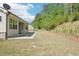 The home is situated with a sprawling, well-maintained lawn that backs up to a beautiful, dense tree line at 3382 Long Creek Dr, Buford, GA 30519