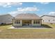 Backyard featuring a concrete patio and a well-maintained lawn at 3382 Long Creek Dr, Buford, GA 30519