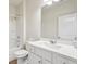 Cozy bathroom with a toilet, shower-tub combo, and vanity with a large mirror at 3382 Long Creek Dr, Buford, GA 30519