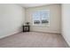 Bedroom with neutral carpet, a window offering natural light, and a side table at 3382 Long Creek Dr, Buford, GA 30519
