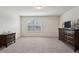 Spacious bedroom featuring neutral carpeting, window providing natural light, and ample space for furnishings at 3382 Long Creek Dr, Buford, GA 30519