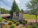 Welcome to Trinity Falls; Lush landscaping and the stone community sign enhance the entrance at 3382 Long Creek Dr, Buford, GA 30519