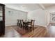 Formal dining room featuring hardwood floors, elegant wainscoting, and a large table with seating for eight at 3382 Long Creek Dr, Buford, GA 30519