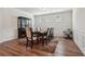 Formal dining room featuring hardwood floors, elegant wainscoting, and a large table with seating for eight at 3382 Long Creek Dr, Buford, GA 30519