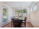 Bright dining area featuring a table set for six, large windows, and a view of the outdoors at 3382 Long Creek Dr, Buford, GA 30519