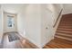 Bright entryway featuring wood-look flooring, staircase, and access to other rooms at 3382 Long Creek Dr, Buford, GA 30519