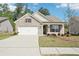 Charming single-story brick home with a two-car garage, well-kept lawn and inviting curb appeal at 3382 Long Creek Dr, Buford, GA 30519